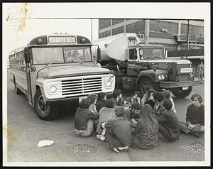 Members of the Non-Violent Direct Action Group block bus and oil truck at Army Base.