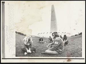 Early Arrivals -- Dan Beal of Naperville, Ill., and Pat Anderson of Syracuse, N.Y., foreground, are among early arrivals in Washington for tomorrow's anti-war rally. Distortion in picture results from the extreme wide-angle lens used by the photographer.