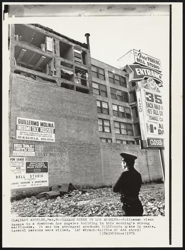 Damage Scene in Los Angeles -- Policeman views damage to a downtown Los Angeles building in this morning's strong earthquake. It was the strongest southern California quake in years. Several persons were killed.