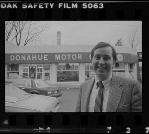 Man in front of Donahue Motor Co.