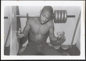 Young man lifting weights