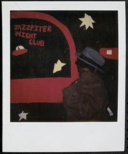 Posing in a trench coat and hat