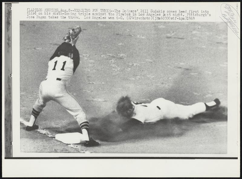 Reaching for Three -- The Dodgers' Bill Sudakis comes head first into third on his sixth-inning triple against the Pirates in Los Angeles last night. Pittsburgh's Jose Pagan takes the throw. Los Angeles won 6-0.