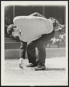 Umpire brushing off plate