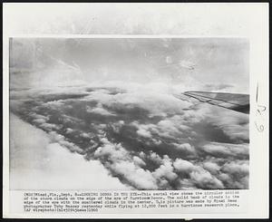 Looking Donna in the Eye--This aerial view shows the circular motion of the storm clouds on the edge of the eye of Hurricane Donna. The solid bank of clouds is the edge of the eye with the scattered clouds in the center. This picture was made by Miami News photographer Toby Massey yesterday while flying at 12,000 feet in a hurricane research plane.