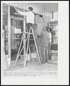 Preparing for Hurricane--Businessmen at Ocean City are shown boarding up their places of business in preparation for Hurricane Gladys. The Hurricane now has the mid-Atlantic Coast on hurricane alert.