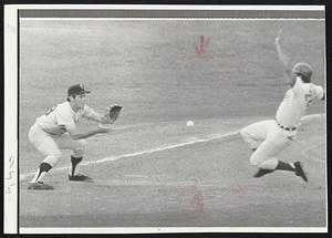 Minnesota Twins third baseman prepares to catch a throw and make play on a sliding runner