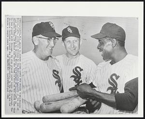 Sarasota, Fla. - Minoso Joins Lopez For Fourth Time - Minnie Minoso, right, given his release by the Washington Senators at the end of last season, reports to Chicago White Sox manager Al Lopez, left, in Sarasota today. If Minnie can made the team it will be the third time that he has played with Chicago. He also played under Lopez in Cleveland. The St. Louis Cardinals traded Joe Cunningham, center, to the White Sox for Minoso a couple years ago.