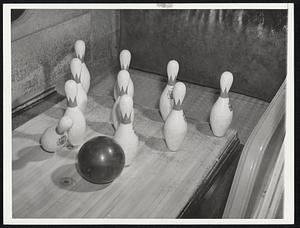 Bowling--Sport of Millions New York- A perfect hit for a strike. The ball has struck the number one or king pin a glancing blow and is about to rash into the number three pin. Subsequent movement of the ball and the first and third pins ordinarily will topple the remaining pins for the strike.