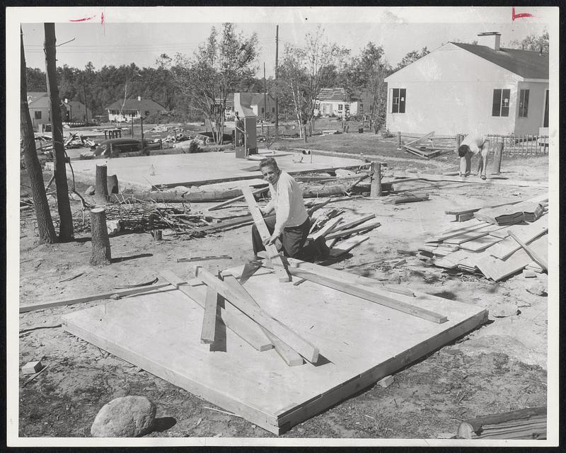 From The Ground Up, Kenneth Keough of Holden (foreground) is rebuilding his pre-fabricated home himself. The floor and heating unit behind him mark where his former house stood before the June 9 tornado.