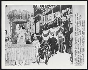 Mardi Gras Reaches Climax--The high point of New Orleans' Mardi Gras celebration came today as Dr. Alton Ochaner, King of Rex, greets the Queen of Carnival, Elizabeth Nicholson, shown at extreme right in reviewing stand from which she saw the parade.