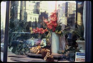 Flowers in a vase in a store window