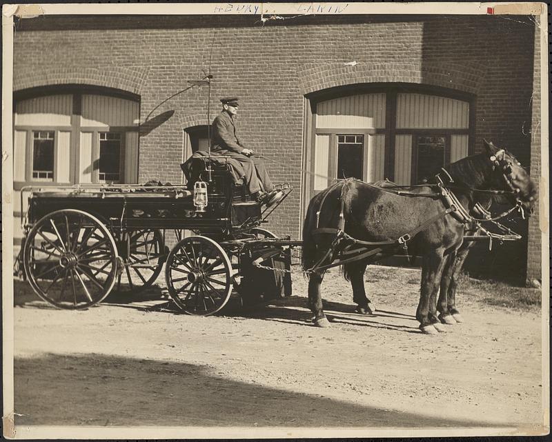 Henry Lakin driving a horse-drawn wagon