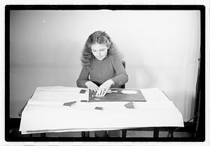 A girl matching fitting shapes in a puzzle