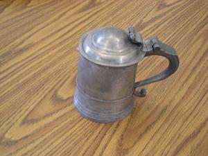 Cylindrical lidded tankard with scrolled handle