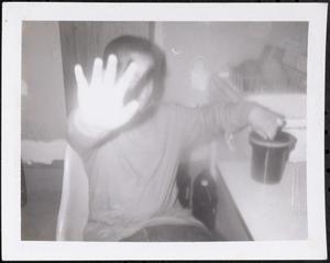 Boy holding up his hand