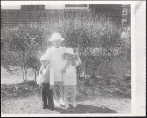 Three children in dress clothes and hats