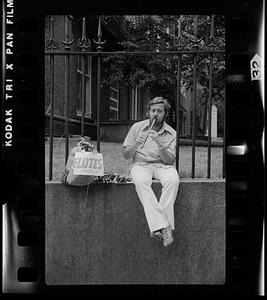Flute seller demonstrates his wares, South End
