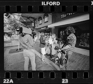 Market researcher interviews customers at shopping mall in Brighton, Brighton