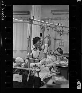 Mass. General Hospital student nurse cheers a young patient, Boston