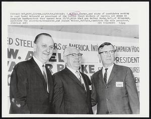 I.W. Abel, center, and slate of candidates seeking to oust David McDonald as president of the United Steel Workers of America are shown in campaign headquarters they opened here 12/19. With Abel are Walter Burke, left, of Milwaukee, candidate for secretary-treasurer, and Joseph Molony, Buffalo, candidate for vice president.