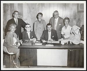 Aids Research--Herbert A. Abramson, N. E., Kidney Disease Foundation president, signs contract for “Mardi Gras Night” set for Sept. 9 at Commonwealth Club with proceeds going to research. Planning event, from left, Mrs. Nathan Wolff, Herb Feine, Daniel J. McDevitt, Mrs. Paul Later, Phil Goldstein and Mrs. Stanley Demerer.