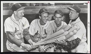 Pretty Good Bat-Wielder – Manager Eddie Stanky, right, of St. Louis Cardinals, poses on steps of dugout at training camp with three of his heavy hitters he hopes will repeat or better last season’s performances. Left to right: Red Schoendienst, who hit .315; Stan Musial, a .330 hitter; Wally Moon, National League rookie of the year in 1954, who hit .304, and Stanky.