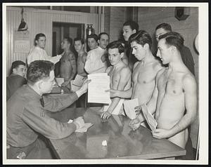 CCC Enrollment Starts. New York, Jan. 5 -- with 50,742 men to be enrolled in the Civilian Conservation Corps, throughout the Nation by Jan. 20, army recruiting offices here today began examination of hundreds of applicants. Corporal Elvin Edge is shown handing reports to some of the candidates after their height and weight had been checked.