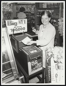 N.Y. Lottery Now A Success. New York: Mrs. James Donoghue tops off her shopping in a supermarket (A&P) by purchasing a $1.00 New York States lottery ticket from an automatic vending machine. The machine is the newest "gimmick" to promote the lottery, which nearly went broke in its first two years of operation but is now a healthy $30 million a year-plus money maker.