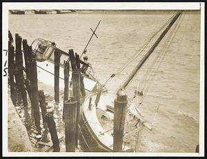 The roaring gale swept these two power cruisers into a crash at Commercial Point, Dorchester. They had been anchored off the Savin Hill Yacht Club.