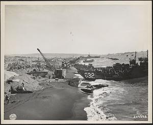 In foreground is LVT knocked out by [Japanese] artillery during unloading operations on Iwo Jima