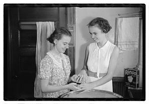 Women doing laundry with a washing machine