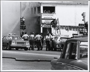Harvey's Hardware at the corner of Great Plain Avenue and Chestnut Street, during fire of May 22, 1977