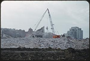 Rubble and crane in front of buildings, West End, Boston