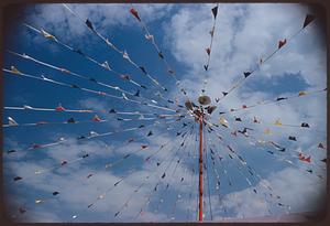 View looking up at pole with radiating lines of pennants, Boston