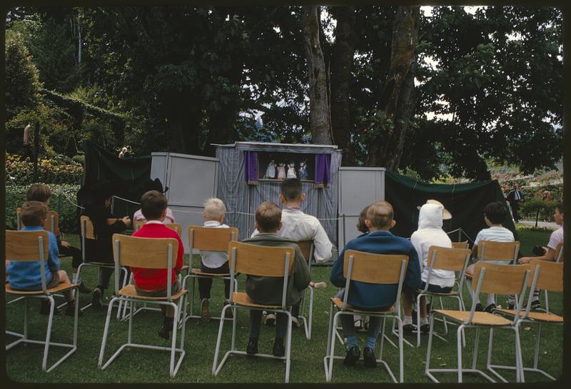 Children watching outdoor puppet show, British Columbia