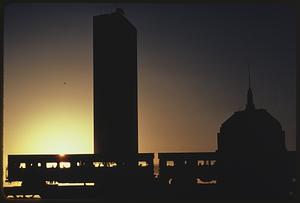 Elevated Orange Line train and the Hancock Tower at sunset