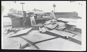 Hurricane Ione put this bridge out of commission at New Bern, N. C. High water washed out approaches, stranding these cars.