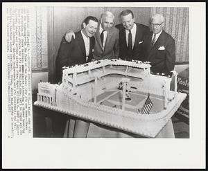 Celebrate Athletics’ Move--A giant cake with all the trimmings--in the form of the Kansas City A’s new home--draws the attention of these baseball enthusiasts attending a dinner honoring those who helped obtain the A’s from Philadelphia. Left to right are Joe E. Brown, stage and motion picture star; Mayor William E. Kemp of Kansas City; Arnold Johnson, Chicago businessman and A’s president; and Will Harridge, American League president. Brown, whose main hobby is baseball, was the featured speaker.