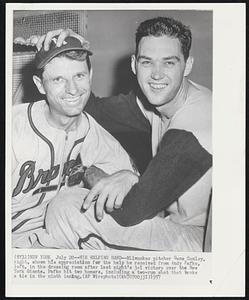 New York – His Helping Hand – Milwaukee pitcher Gene Conley, right, shows his appreciation for the help he received from Andy Pafko, left, in the dressing room after last night’s 3-1 victory over the New York Giants. Pafko hit two homers, including a two-run shot that broke a tie in the ninth inning.