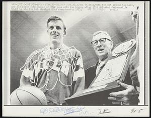 John Vallely, with the net around his neck and his coach John Wooden of UCLA with the trophy after UCLA defeated Jacksonville 80-69 to win its 4th straight NCAA championship 3/21.