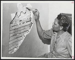 Where Lightning Struck a bedroom wall of her third-floor apartment at 374 Columbus avenue is being inspected by Miss Ethel Hill. Considerable damage was done to the bedroom, but Hiss Hill was unharmed. When the lightning struck she was in the kitchen, which was not damaged.