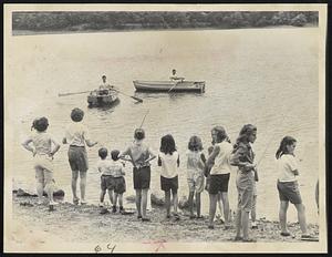 Life Guards patrol while youngsters line banks of Jamaica Pond for today's 10th annual Fishing Rodeo sponsored by The Traveler and the Boston Parks and Recreation Dept. Guards are Tom McPhee and Mike DeSisto. Contest was won by John Paul Curtis, 4, of West Roxbury.