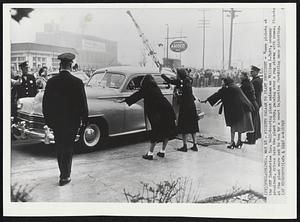 Pickets Salaam to Plant President- Women pickets at the SKF Industries Inc. ball-bearing plant salaam as William L. Batt, company president, drives into the plant today, passing over a rug strewn with roses. Pickets at the plant were cut to ten by a court injunction forbidding mass picketing.