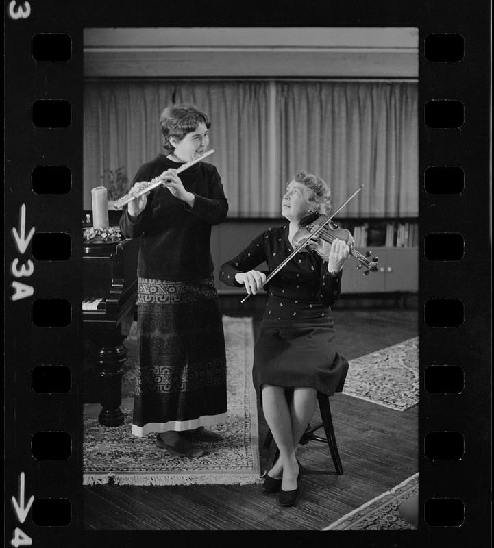 Lea Pearson playing flute and Florence Pearson playing violin