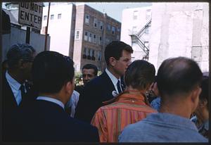 People standing around man wearing St. Anthony button