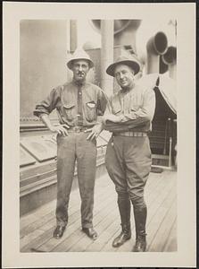 Two men standing on a ship deck