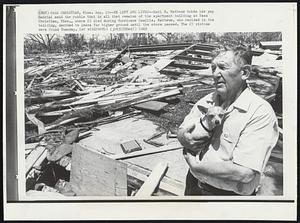 He Left and Lived--Earl B. Mathews holds his pup Gabrial amid the rubble that is all that remains of the apartment building at Pass Christian, Miss., where 23 died during Hurricane Camille. Mathews, who resided in the building, decided to leave for higher ground until the storm passed. The 23 victim were found Tuesday.