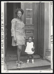 This ghetto woman wonders as any good mother do of her child's future. Will it be any better or worst than this of today?