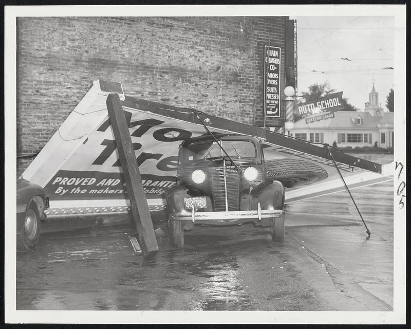 Billboard Lands On Automobile - High winds caused by the northeast storm early today toppled this billboard at Chestnut Hill avenue and Beacon street onto this parked automobile in a Cleveland Circle parking space.